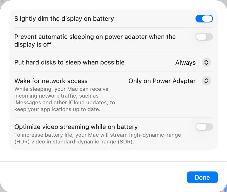 macOS 26.5.2, System Settings, Battery, Options: the switch Prevent automatic sleeping on power adapter when the display is off, between Slightly dim the display on battery and Put hard disks to sleep when possible