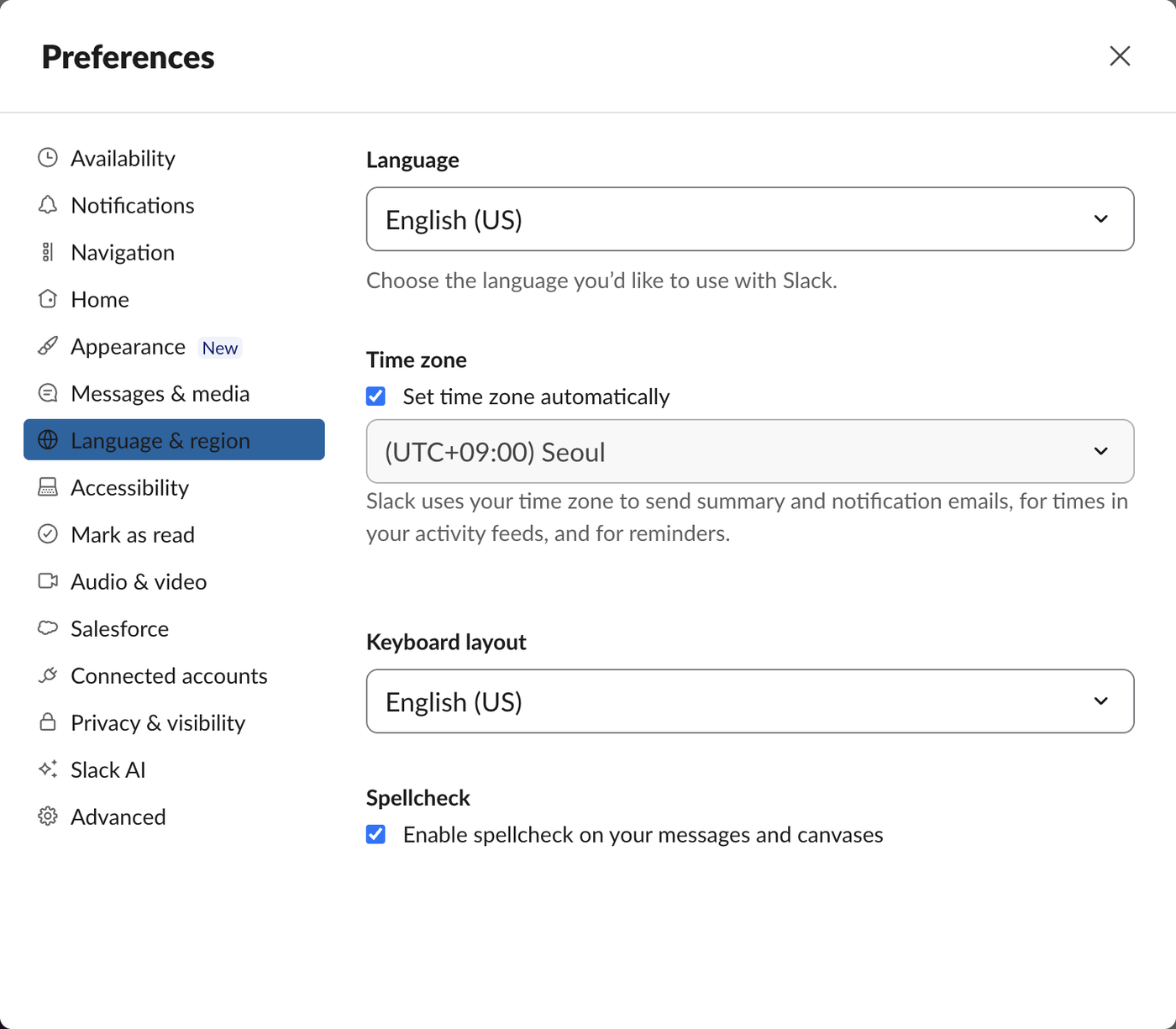 Slack Preferences on the Language and region tab with Language set to English US, Time zone set automatically to UTC+09:00 Seoul, Keyboard layout English US, and Spellcheck enabled. No translation setting