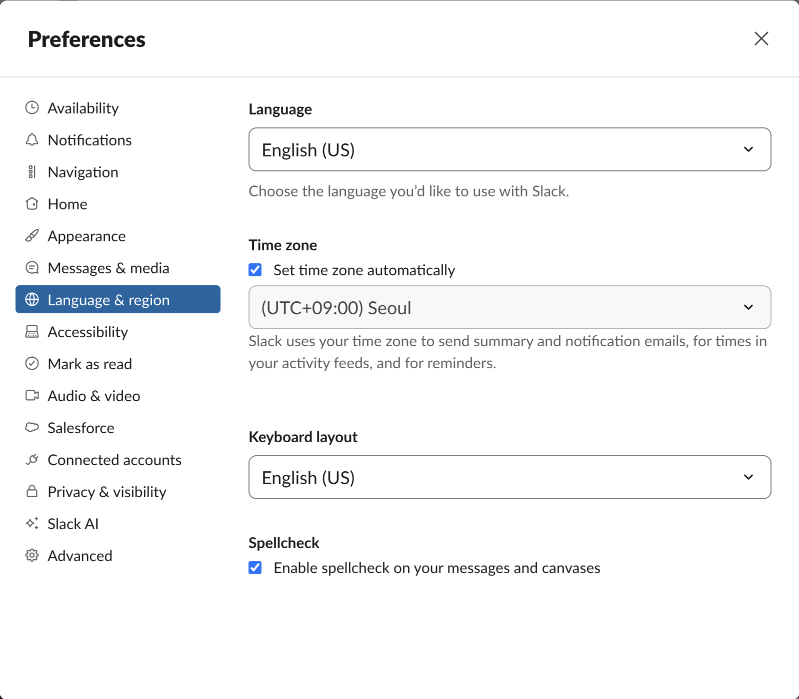 Slack web Preferences, Language and region: Language English US, Time zone set automatically to Seoul, Keyboard layout English US, and under Spellcheck a ticked box reading Enable spellcheck on your messages and canvases